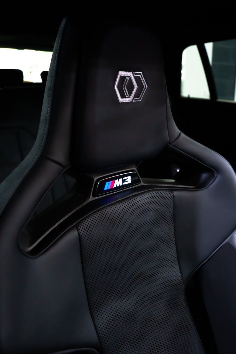 BMW G8X gloss black seat badges