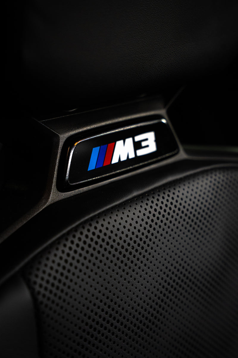 BMW G8X gloss black seat badges