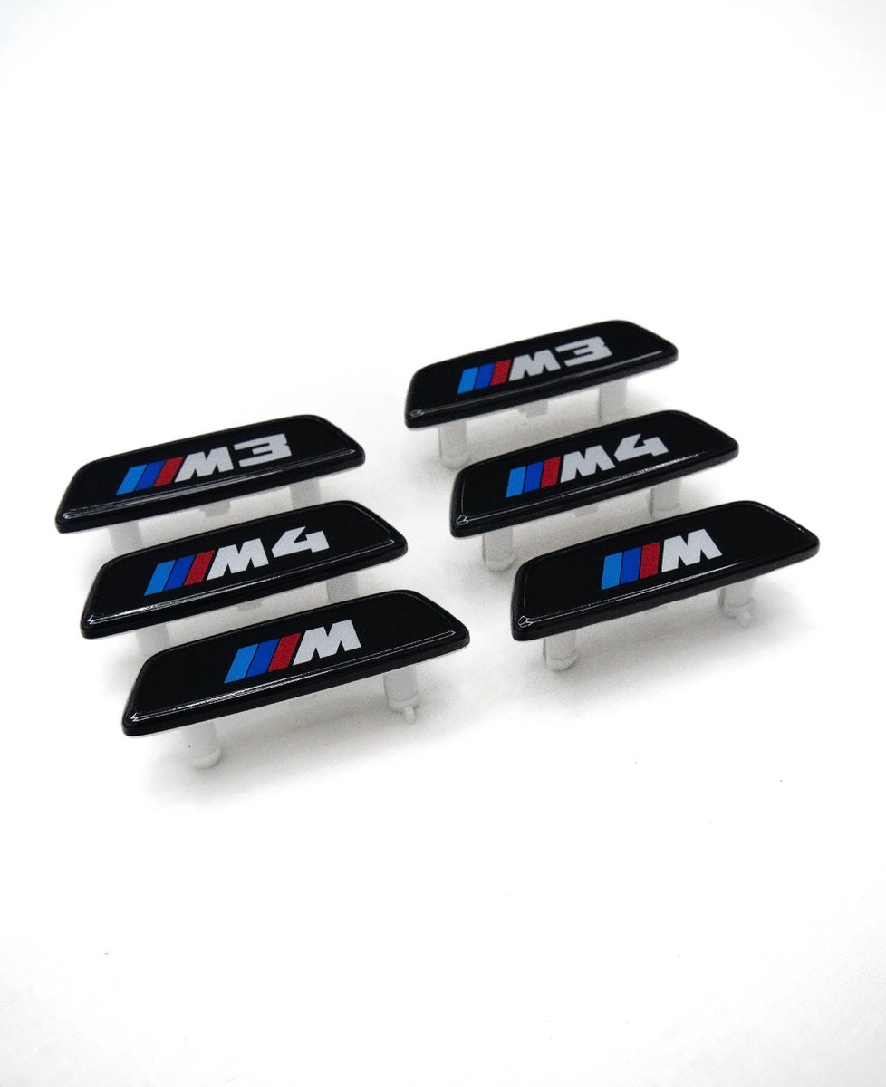 BMW G8X gloss black seat badges